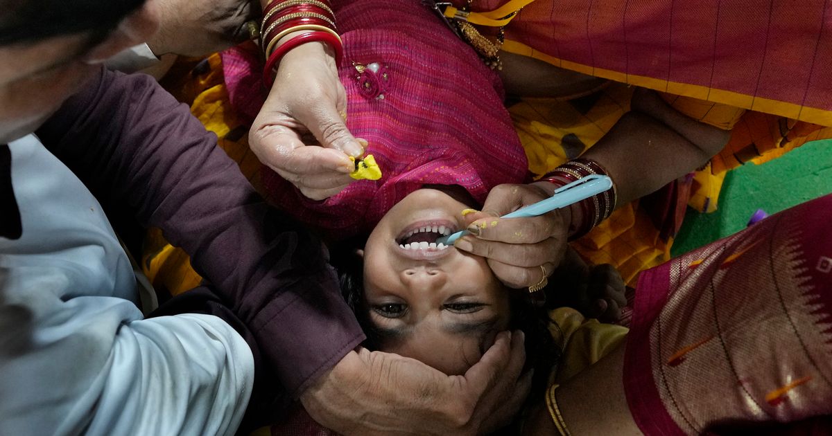 AP PHOTOS Myriad people flock to Indian city to swallow live fish with
